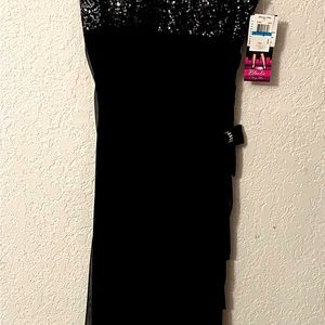 Long dress with sequin bodice and rhinestone details on straps and bow.